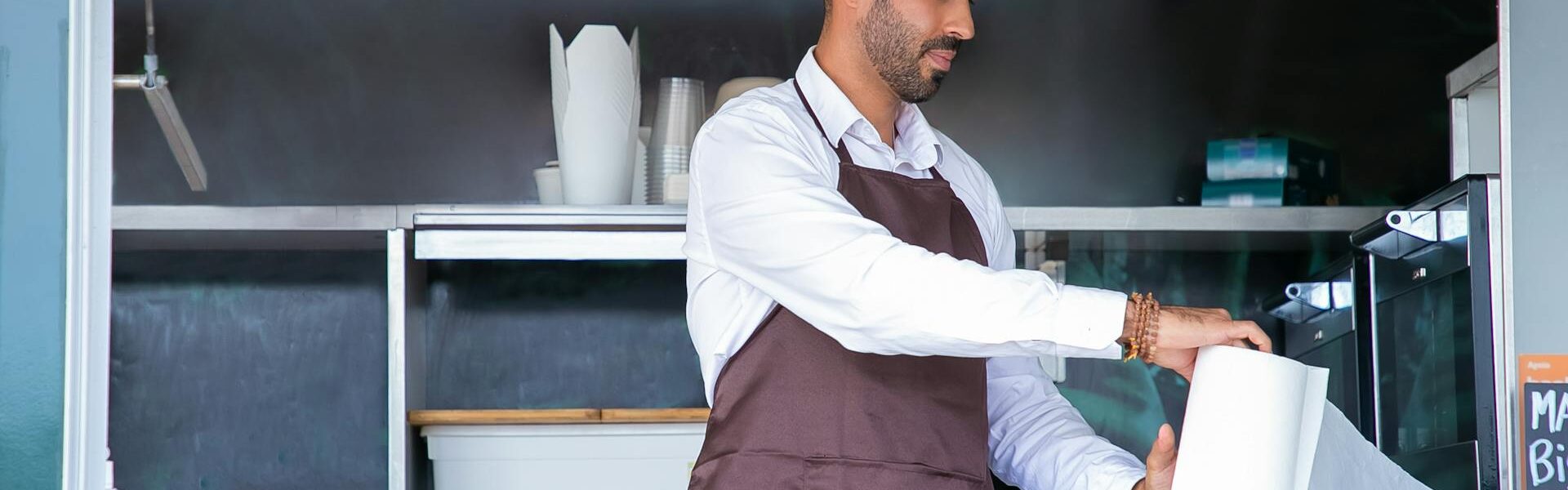 Business owner working inside a food truck.