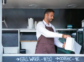 Business owner working inside a food truck.