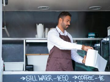 Business owner working inside a food truck.