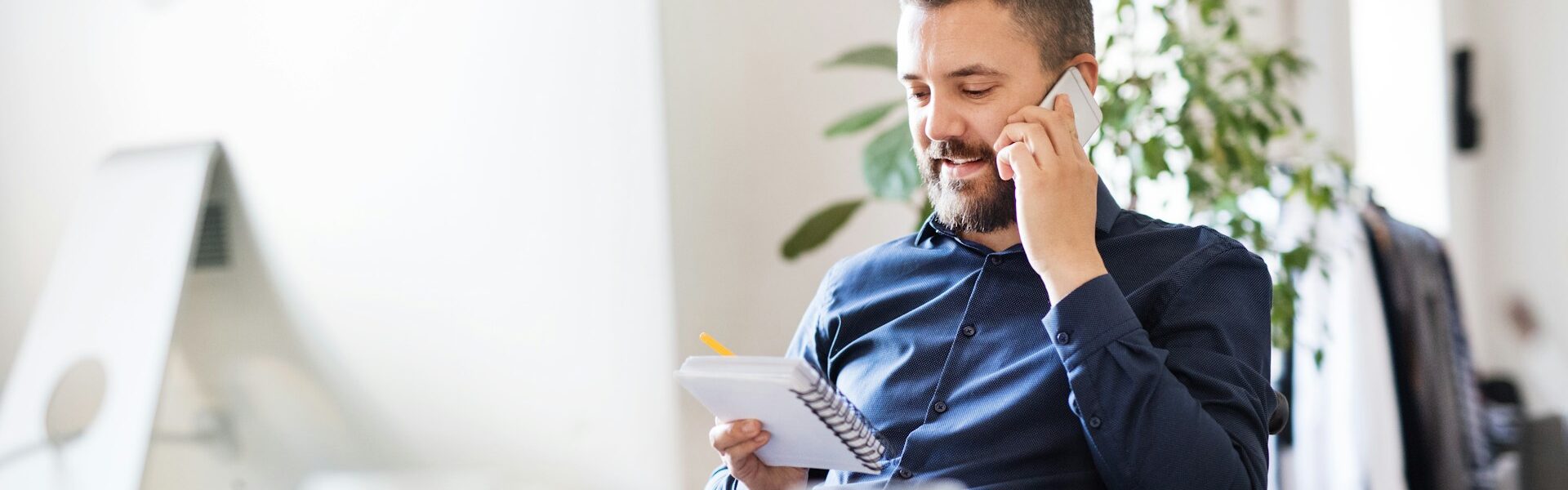 Man working while taking a phone call