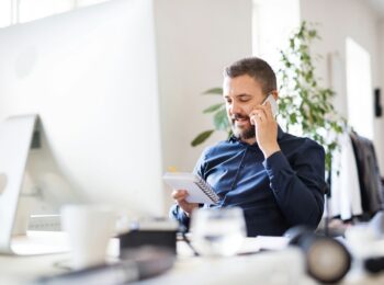 Man working while taking a phone call